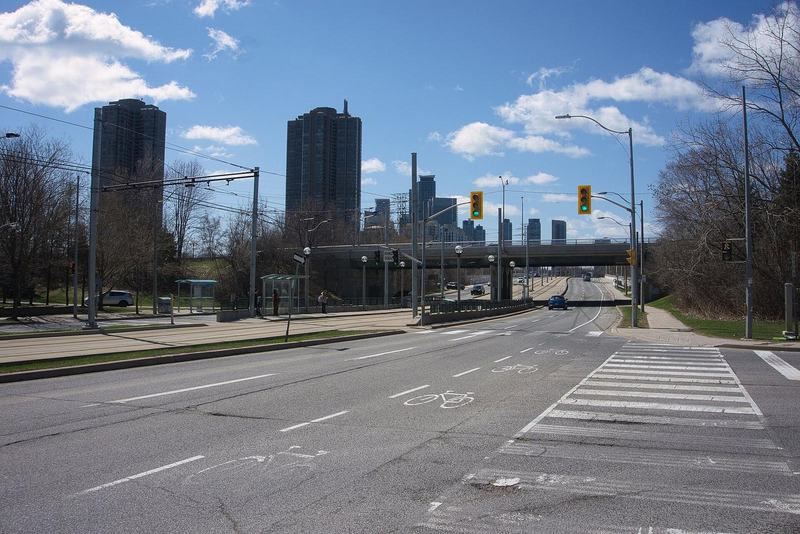The Queensway at South Kingsway in Toronto, with the streetcar right-of-way, traffic lights and condo towers in the distance